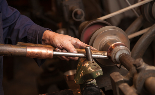 Franco Minazzi one of Ruffoni partner artisans shaping a copper piece