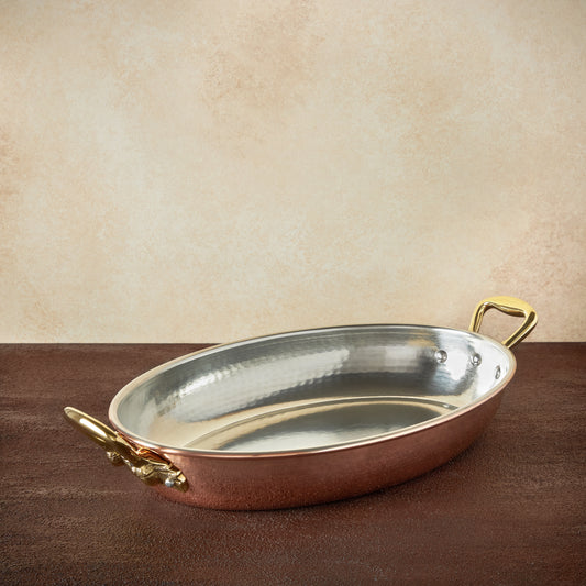 Hammered copper 14" Oval Gratin lined with high purity tin applied by hand over fire and bronze handles, from Ruffoni Historia collection