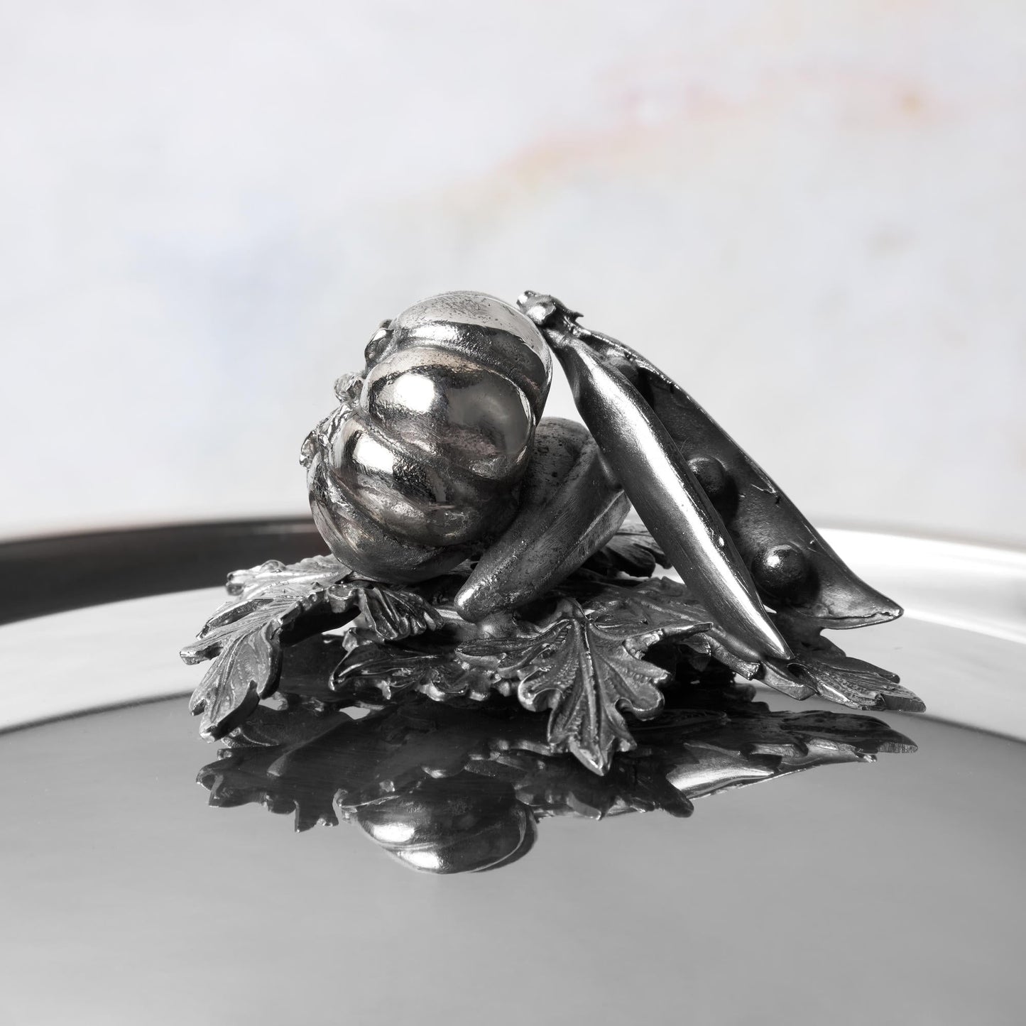 Decorated knob finial representing tomato, peas and pepper, cast in solid bronze and silver plated, on Opus Prima stainless steel lid by Ruffon