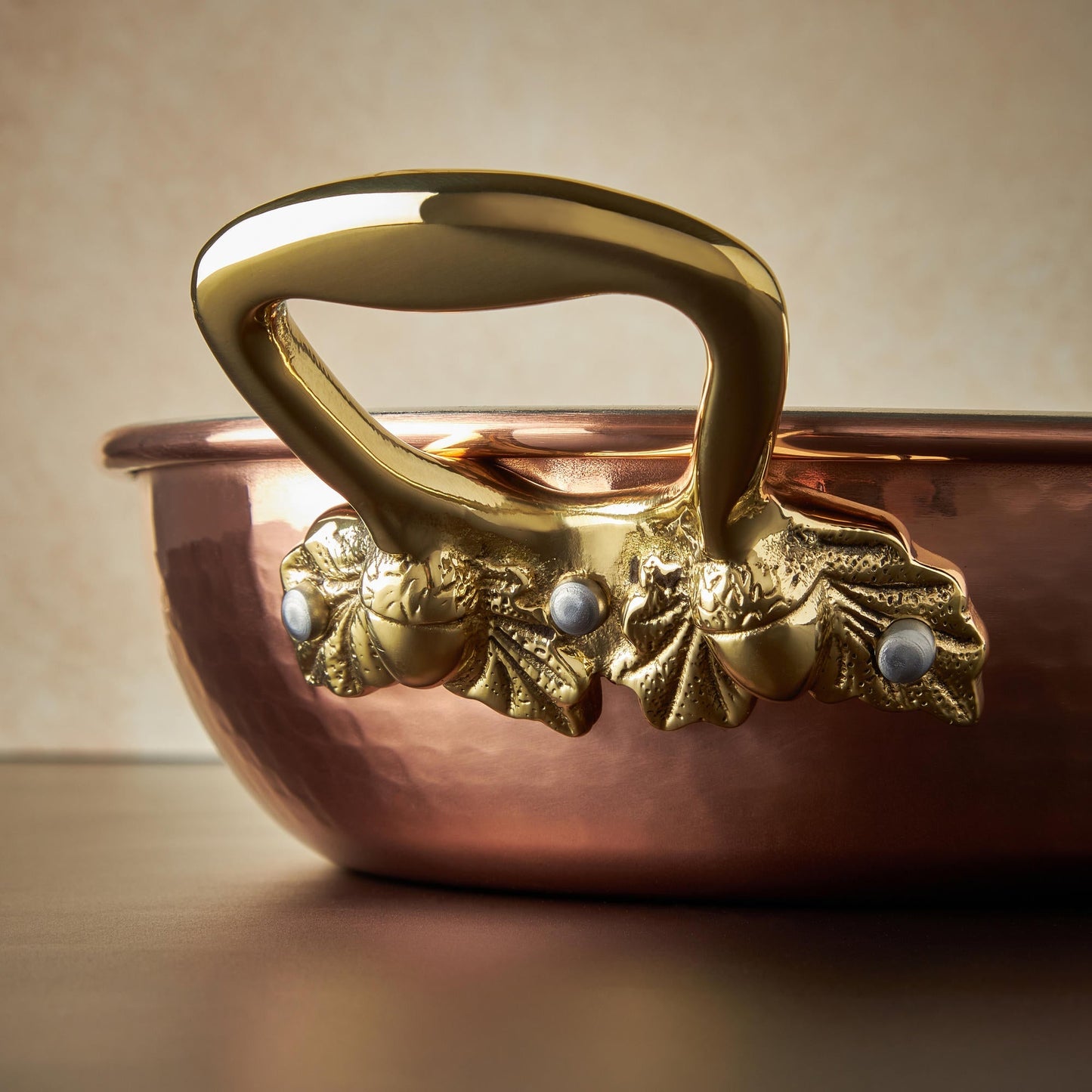 Beautiful bronze handle decorated with acorns on Historia hammered copper cookware by Ruffoni