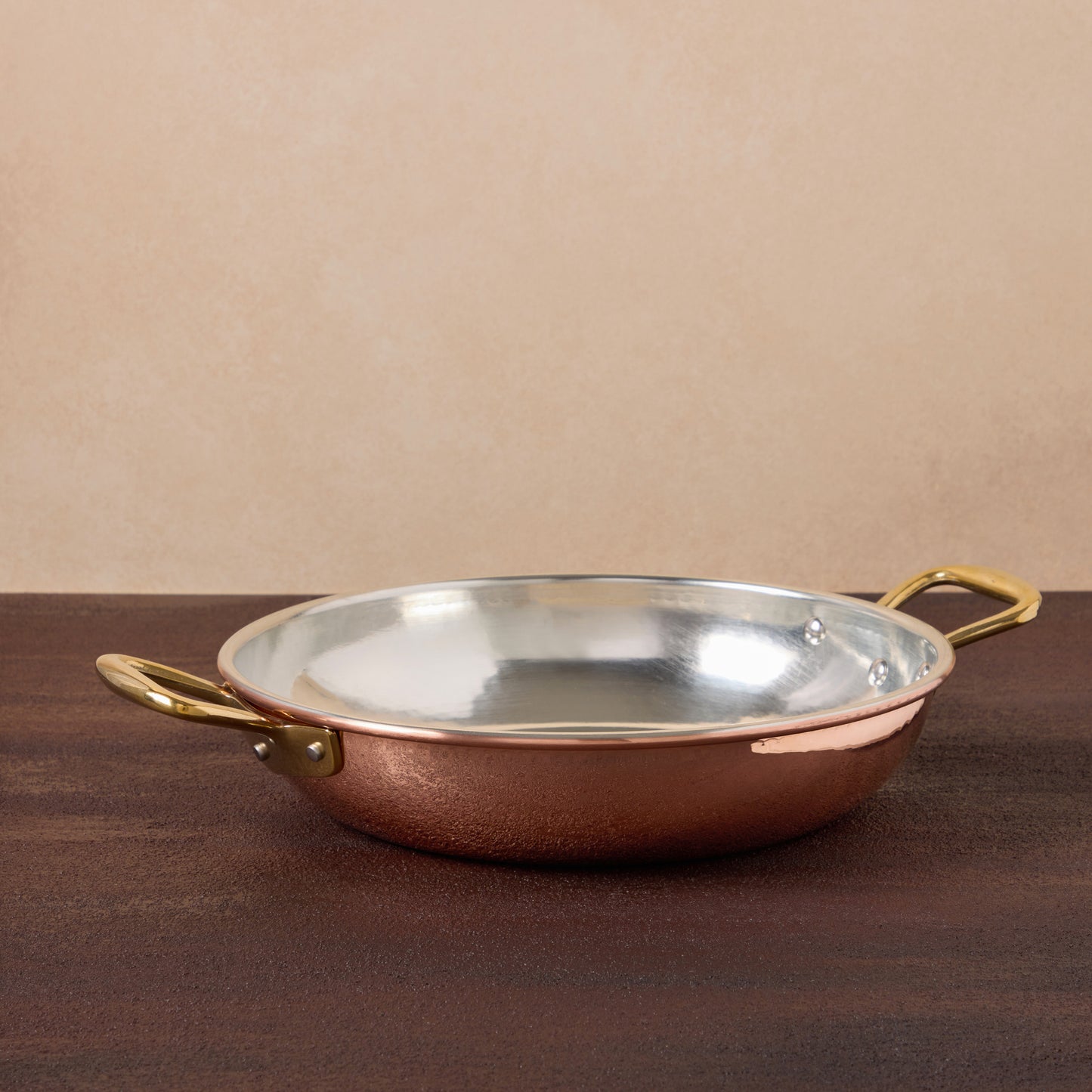 A classic with a twist - Ruffoni copper frying pan with two side handles to ensure a convenient and elegant transition from stovetop to oven and tabletop. Explore timeless craftsmanship now