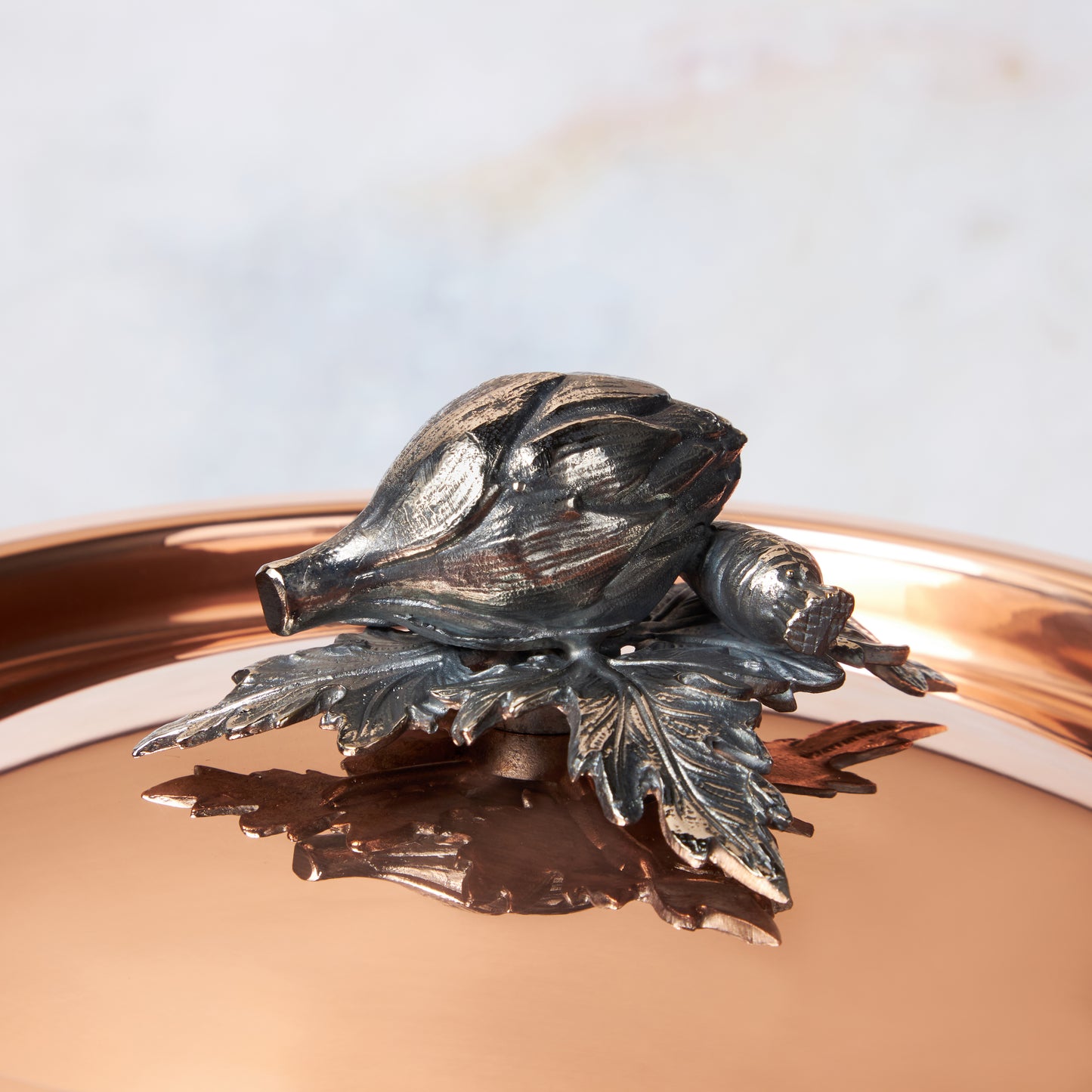 Decorated knob finial representing artichoke and carrot, cast in solid bronze and silver plated, on Opus Cupra clad copper lid by Ruffoni