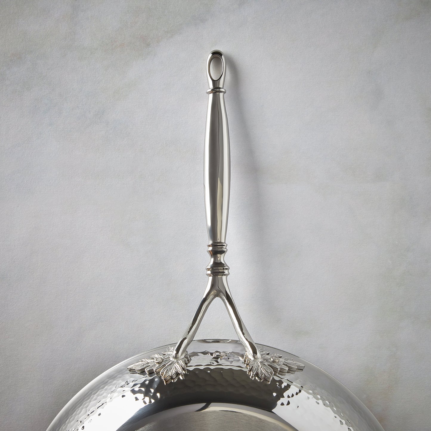 Beautiful stainless steel long stick handle decorated with delicate leaves on Opus Prima cookware by Ruffoni