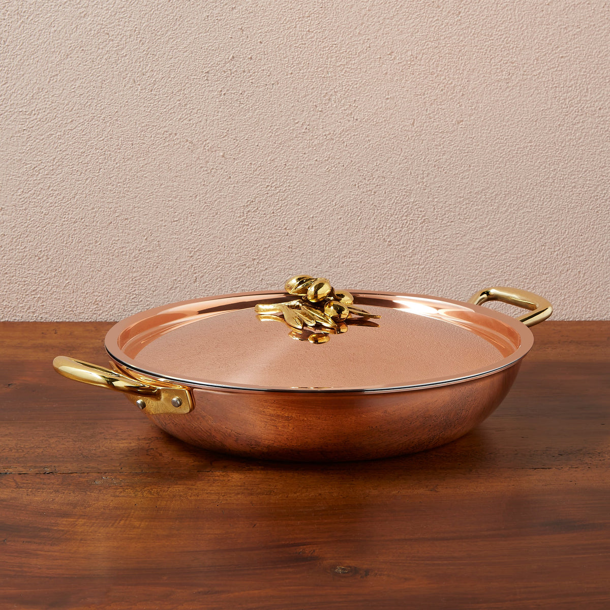 Ruffoni Olivia Cupra 12-inch serving frying pan copper cookware with stainless steel lining, brass handles, and decorated lids with brass olive and leaf knob finials
