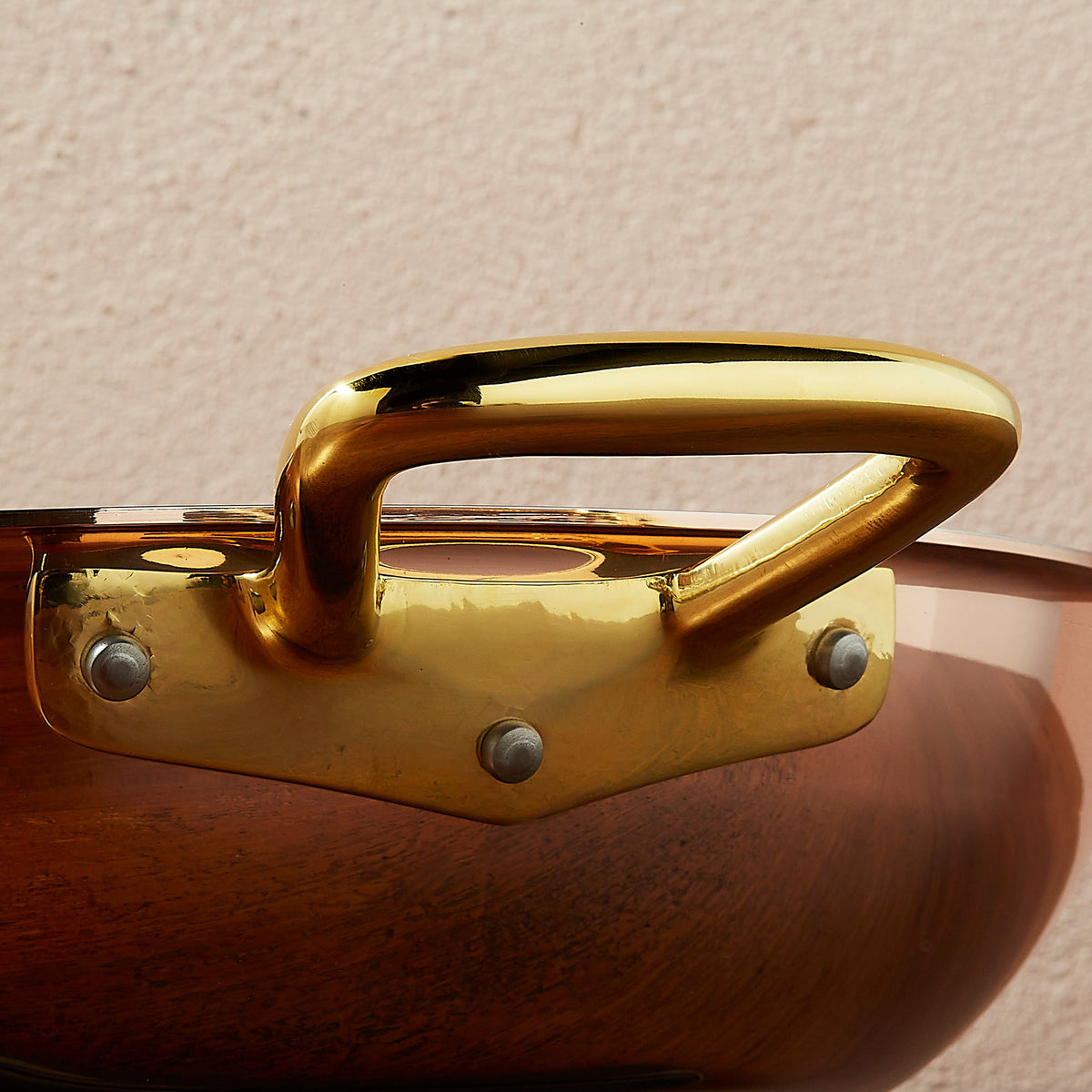 Riveted brass side handle on Ruffoni Olivia Cupra copper cookware