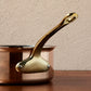 Side view of the  brass handle on a Ruffoni Olivia Cupra copper saucepan
