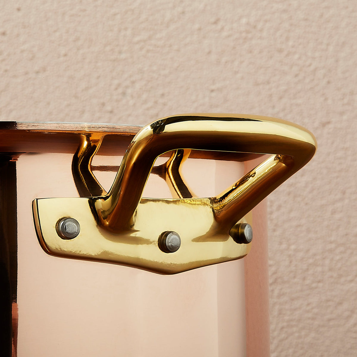 Riveted brass side handle on Ruffoni Olivia Cupra copper cookware