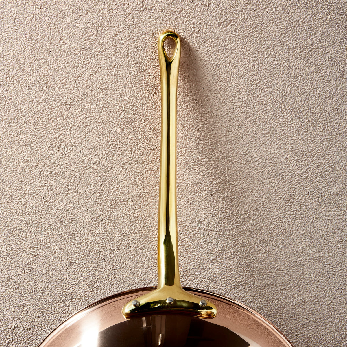 Long brass stick handle riveted to a Ruffoni Olivia Cupra copper frying pan