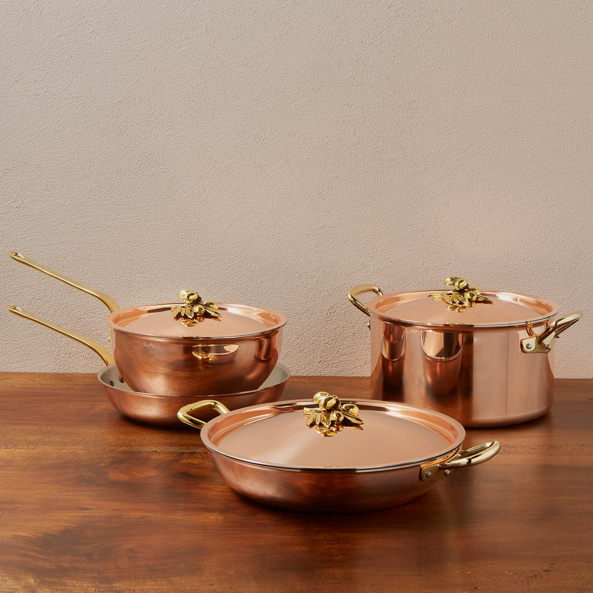 Ruffoni Olivia Cupra 7-piece copper cookware set with stainless steel lining, brass handles and decorated lids with brass olive and leaf knob finials