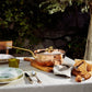 Olivia Cupra copper Chef Pan on a linen tablecloth