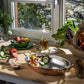 Oval gratin preparing ratatouille in a sunlit kitchen