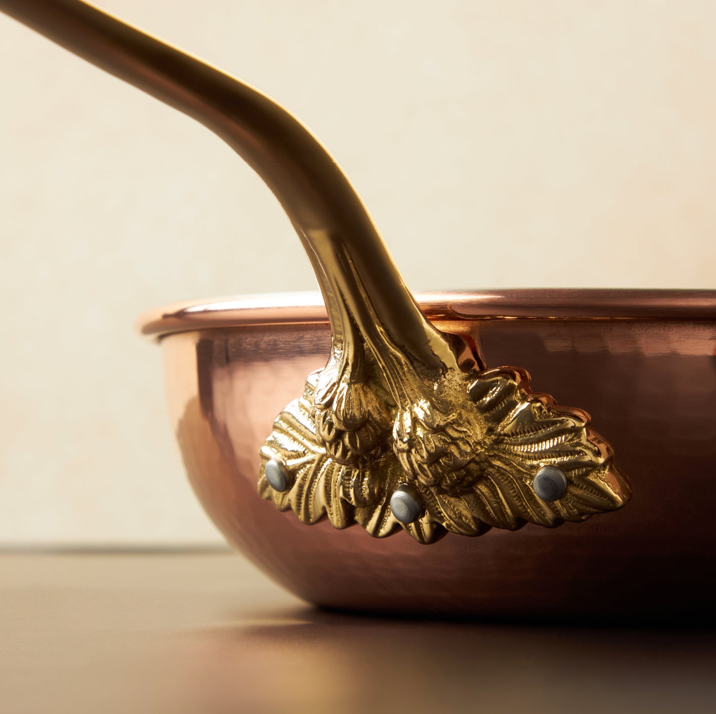 Beautiful bronze l stick handle decorated with acorns on Historia cookware by Ruffoni