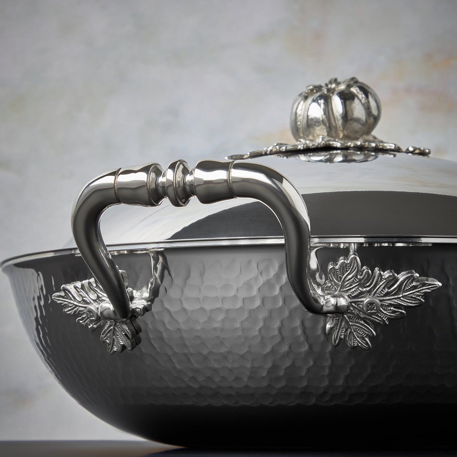 Beautiful stainless steel handle decorated with delicate leaves on Opus Prima cookware by Ruffoni